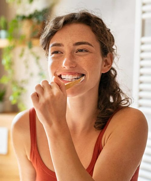 Smiling,Young,Woman,Brushing,Teeth,In,Bathroom.,Happy,Girl,Looking